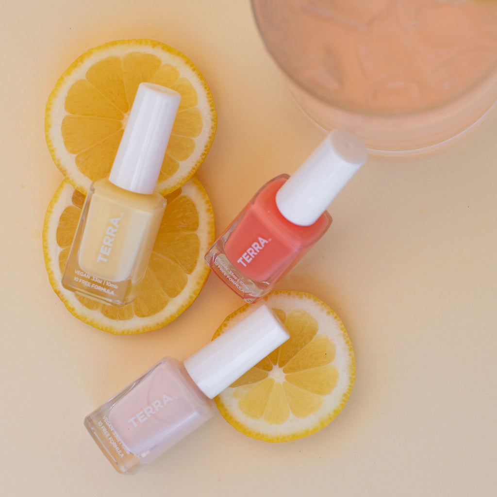 Terra Beauty Bars Summer Trio Refreshments Collection Nail Polish in glass packaging and white caps to include number 34 Sweet Lemonade (light yellow), number 35 White Frosty Pink (soft white pink), number 36 Watermelon Coral color on top of lemon slices
