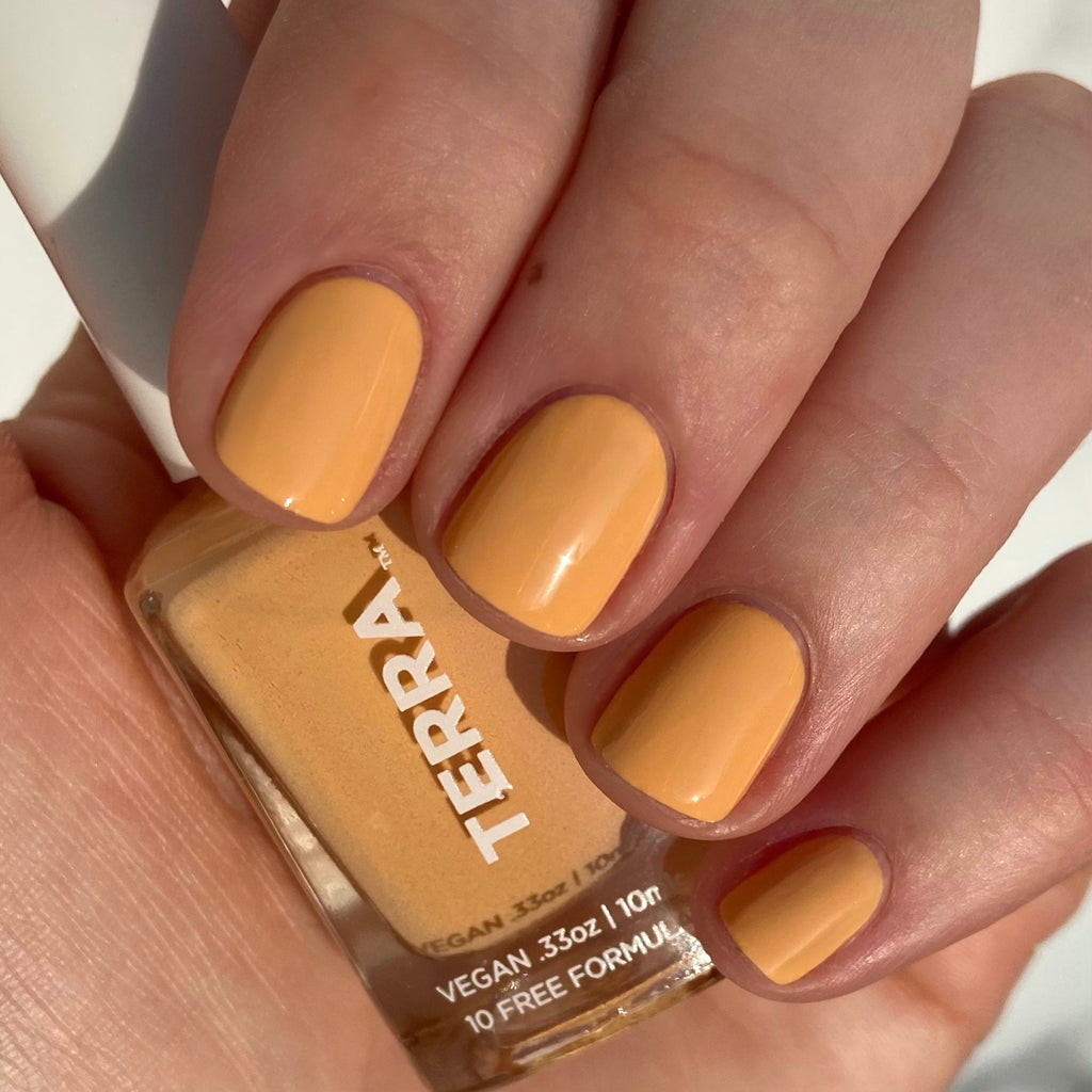 Terra nail polish number 16 desert sun yellow color swatched on nails.