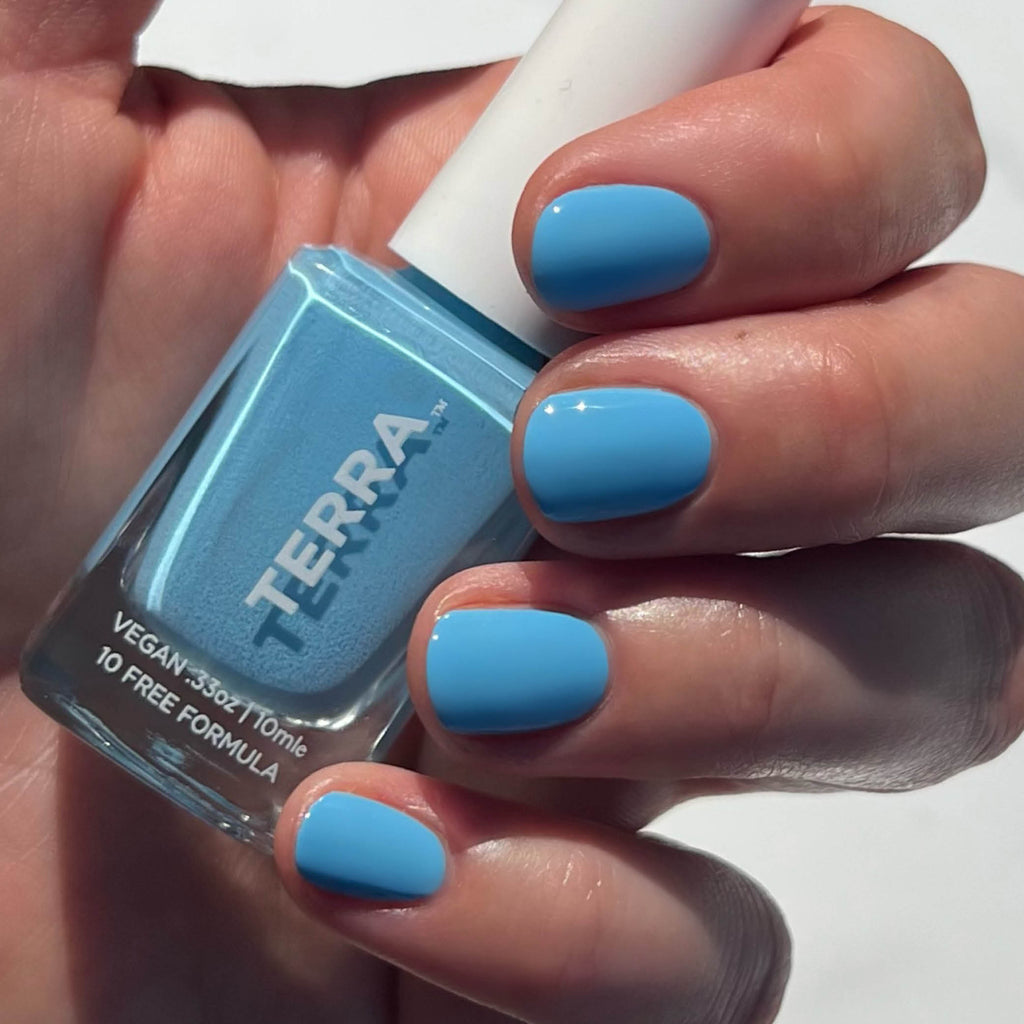 Clean blue nail polish bottle and swatch on nails