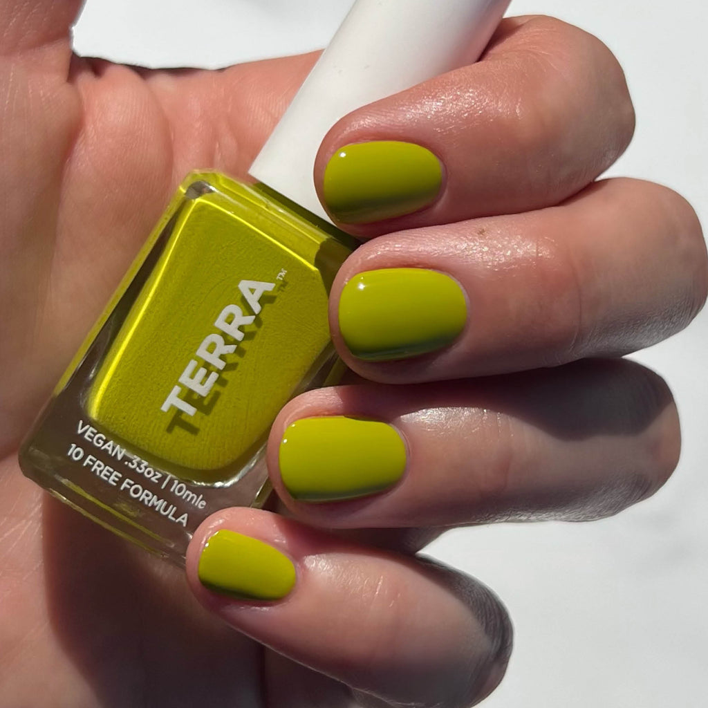 Lively green nail polish on nails and bottle