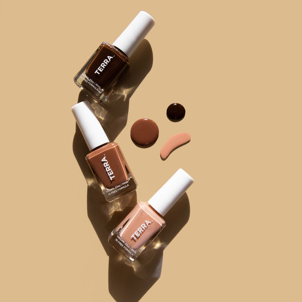 Terra Earth Tones Nail Polish Collection featuring Number 13 Dark Tan, number 42 Earthernal and Number 11 Deep Brown nail polish bottles on brown background and 3 accompanying nail swatches 
