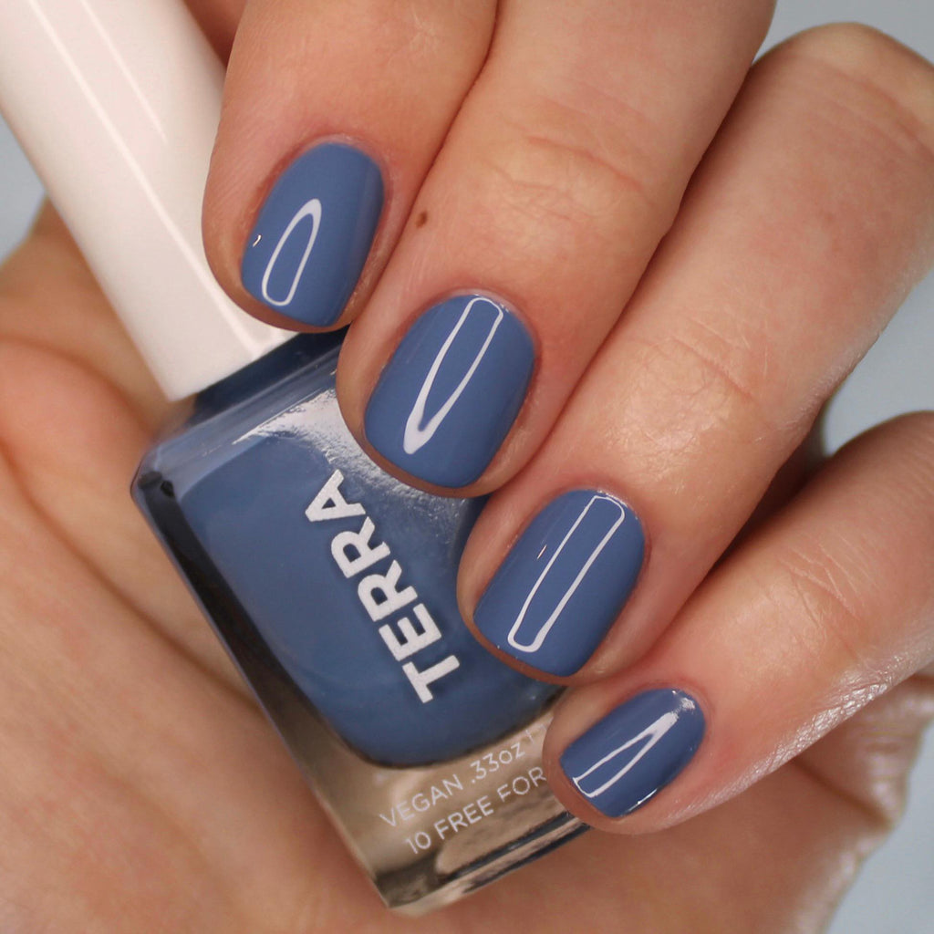 Terra nail polish number 6 warm blue color swatched on nails.
