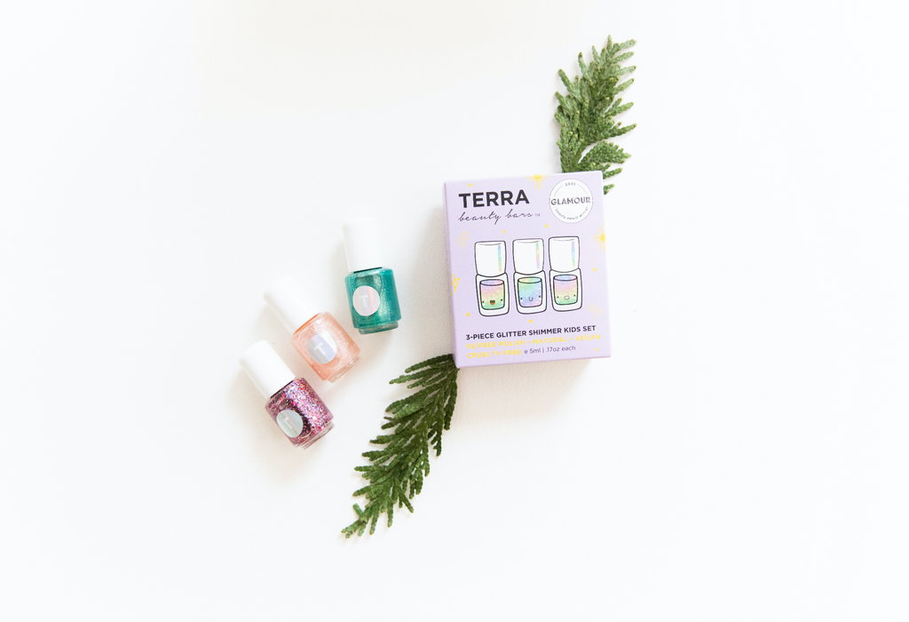 Terra Kids Glitter box and three glitter nail polishes and pine leaves